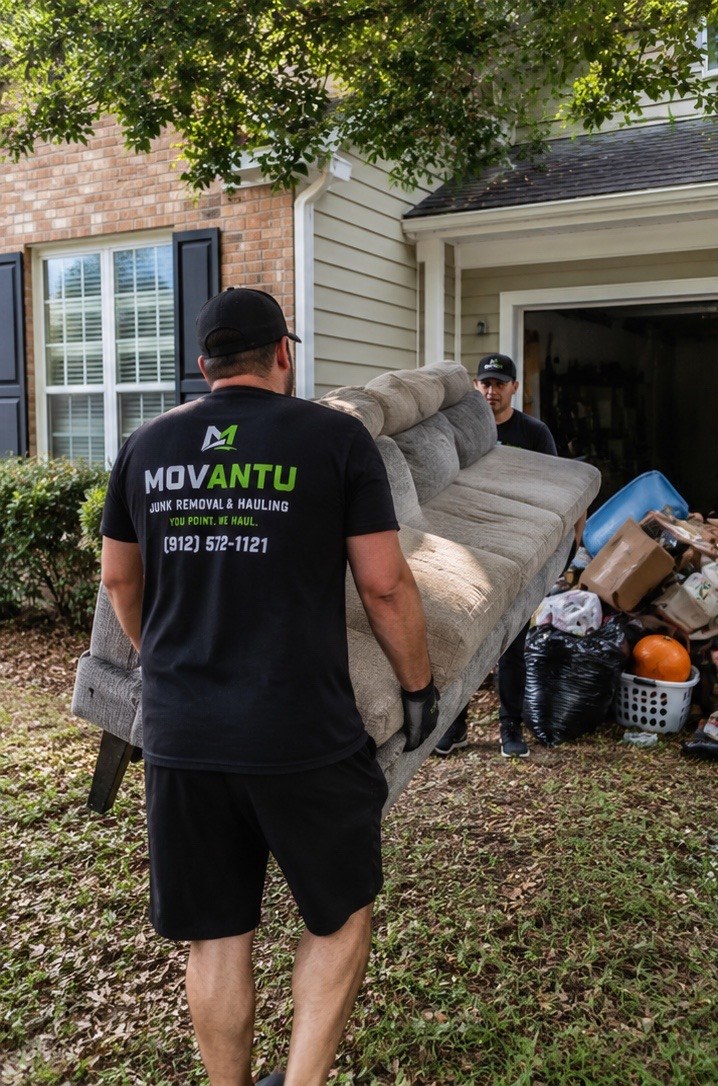 MOVANTU crew carrying an old sofa out of a Savannah home